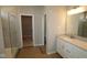 Modern bathroom featuring a glass door shower, vanity with light countertop and a view to a walk-in closet at 4076 Berry Chase Blvd, Greenwood, IN 46143