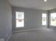 Bedroom with neutral walls, carpeted flooring, and large windows offering natural light to the room at 4076 Berry Chase Blvd, Greenwood, IN 46143