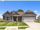 Charming one-story home with gray siding, manicured lawn, and a two-car garage at 4076 Berry Chase Blvd, Greenwood, IN 46143