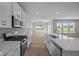 Stylish kitchen featuring white cabinets, quartz countertops, stainless steel appliances, and wood floors at 4076 Berry Chase Blvd, Greenwood, IN 46143