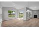 Bright living room with vaulted ceilings, modern fireplace, and sliding glass doors to the backyard at 4076 Berry Chase Blvd, Greenwood, IN 46143