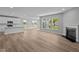Open living space featuring a kitchen, living room, fireplace, wood flooring, and natural light at 4076 Berry Chase Blvd, Greenwood, IN 46143