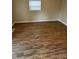 Inviting bedroom featuring beautiful hardwood floors, natural light, and neutral decor at 41 S Warman Ave, Indianapolis, IN 46222