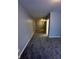 Hallway with gray carpeting leading to an open doorway and freshly painted walls at 41 S Warman Ave, Indianapolis, IN 46222