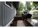 A quaint back porch with a grill and wooden stairs at 4644 N Ritter Ave, Indianapolis, IN 46226