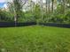 Large, open backyard featuring a fire pit and a privacy fence, creating a serene outdoor space at 4644 N Ritter Ave, Indianapolis, IN 46226