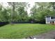 Spacious backyard featuring lush green grass and mature trees at 4644 N Ritter Ave, Indianapolis, IN 46226