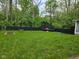 Expansive backyard features a fire pit, trampoline and a porch swing, perfect for outdoor activities at 4644 N Ritter Ave, Indianapolis, IN 46226