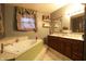 Spacious bathroom with a jacuzzi-style bathtub and a double vanity at 4644 N Ritter Ave, Indianapolis, IN 46226
