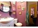 Quirky bathroom with artwork and a small vanity at 4644 N Ritter Ave, Indianapolis, IN 46226