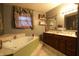 Spacious bathroom with a jacuzzi-style bathtub and a double vanity at 4644 N Ritter Ave, Indianapolis, IN 46226