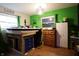 bedroom with green paint, wood floors and modern decor at 4644 N Ritter Ave, Indianapolis, IN 46226
