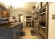 Well-equipped kitchen featuring granite countertops, stainless steel appliances, and stylish gray cabinetry at 4644 N Ritter Ave, Indianapolis, IN 46226