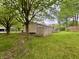 Home's backyard featuring mature trees and a wooden deck at 4718 Tempe Ct, Indianapolis, IN 46241