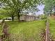 Backyard view of home featuring a wooden deck and mature trees at 4718 Tempe Ct, Indianapolis, IN 46241