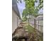 House's backyard features wooden deck with pavers and rock at 4718 Tempe Ct, Indianapolis, IN 46241