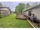 Home's backyard with wooden deck and central air unit at 4718 Tempe Ct, Indianapolis, IN 46241