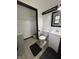 Bathroom with a toilet, a vanity, a black rug, and a view into the walk-in closet at 4718 Tempe Ct, Indianapolis, IN 46241