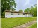 Single-story home with a well-manicured lawn, painted brick, and a two-car garage at 4718 Tempe Ct, Indianapolis, IN 46241