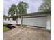 Close up of a single-story house with a two-car garage and landscaped front yard at 4718 Tempe Ct, Indianapolis, IN 46241