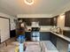 This kitchen has black cabinets, stainless steel appliances, and lovely countertops at 4718 Tempe Ct, Indianapolis, IN 46241