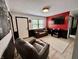 Modern living room with a fireplace, couch, and black and red accent wall at 4718 Tempe Ct, Indianapolis, IN 46241