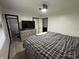 This bedroom features neutral walls, a ceiling fan, and a double closet at 4718 Tempe Ct, Indianapolis, IN 46241