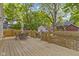 Spacious wooden backyard deck perfect for outdoor dining, with lush greenery at 4725 Boulevard Pl, Indianapolis, IN 46208