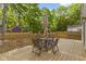 Cozy backyard with wood deck and dining set, perfect for outdoor entertaining at 4725 Boulevard Pl, Indianapolis, IN 46208