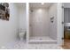 Elegant bathroom featuring a tiled walk-in shower, toilet, and stylish tile flooring at 4725 Boulevard Pl, Indianapolis, IN 46208