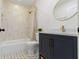 Cozy bathroom features a shower-tub combination and a navy vanity with gold fixtures at 4725 Boulevard Pl, Indianapolis, IN 46208