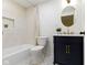 Bright bathroom featuring a white vanity with marble top, gold fixtures and new grey tiled floor at 4725 Boulevard Pl, Indianapolis, IN 46208