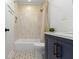 Stylish bathroom features a shower-tub combination and a sleek navy vanity with modern accents at 4725 Boulevard Pl, Indianapolis, IN 46208