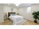 Bright bedroom with a large window, wood-look flooring, and stylish lamps at 4725 Boulevard Pl, Indianapolis, IN 46208