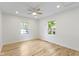 Sunlit bedroom with hardwood floors, neutral walls, and two windows overlooking the outdoors at 4725 Boulevard Pl, Indianapolis, IN 46208