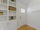 Bright entryway with hardwood floors, built-in shelving, and stylish wainscoting at 4725 Boulevard Pl, Indianapolis, IN 46208