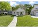 Inviting single-story home with a welcoming front porch and lush green lawn at 4725 Boulevard Pl, Indianapolis, IN 46208
