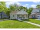 Charming single-story home with a cozy front porch and well-manicured lawn at 4725 Boulevard Pl, Indianapolis, IN 46208