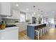 Open concept kitchen features a large island with seating, stylish backsplash, and modern appliances at 4725 Boulevard Pl, Indianapolis, IN 46208