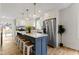 Modern kitchen featuring a large island with seating, stainless steel appliances, and white cabinetry at 4725 Boulevard Pl, Indianapolis, IN 46208