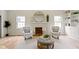 Elegant living room with a fireplace, comfortable seating, and abundant natural light at 4725 Boulevard Pl, Indianapolis, IN 46208