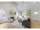 Spacious living room featuring vaulted ceilings, built-in shelving, and hardwood floors at 4725 Boulevard Pl, Indianapolis, IN 46208