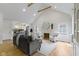 Bright living room with vaulted ceilings, fireplace, and open floor plan to the kitchen at 4725 Boulevard Pl, Indianapolis, IN 46208