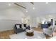 Open-concept living room with hardwood floors, vaulted ceilings, and a view of the kitchen at 4725 Boulevard Pl, Indianapolis, IN 46208