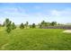 Backyard featuring large green lawn with trees and wooden fence around the property at 4752 Chip Shot Ln, Indianapolis, IN 46235