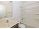 Bathroom showcasing a sink, toilet, and shower-tub combination with built-in shelving at 4752 Chip Shot Ln, Indianapolis, IN 46235