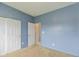 Cozy bedroom featuring a double-door closet with carpet flooring and natural lighting at 4752 Chip Shot Ln, Indianapolis, IN 46235