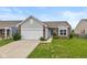 Charming single-story home with a well-manicured lawn, attached garage, and classic brick and siding details at 4752 Chip Shot Ln, Indianapolis, IN 46235