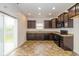 Functional kitchen featuring dark cabinetry, black appliances, and sliding glass door to the backyard at 4752 Chip Shot Ln, Indianapolis, IN 46235