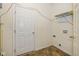A well-lit laundry room features a door, shelving and vinyl flooring at 4752 Chip Shot Ln, Indianapolis, IN 46235